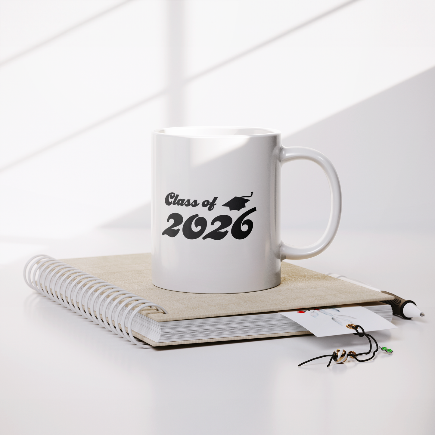 Class_of_2026_11_oz_Mug_-_White_Lifestyle_Notebook_Mockup.png