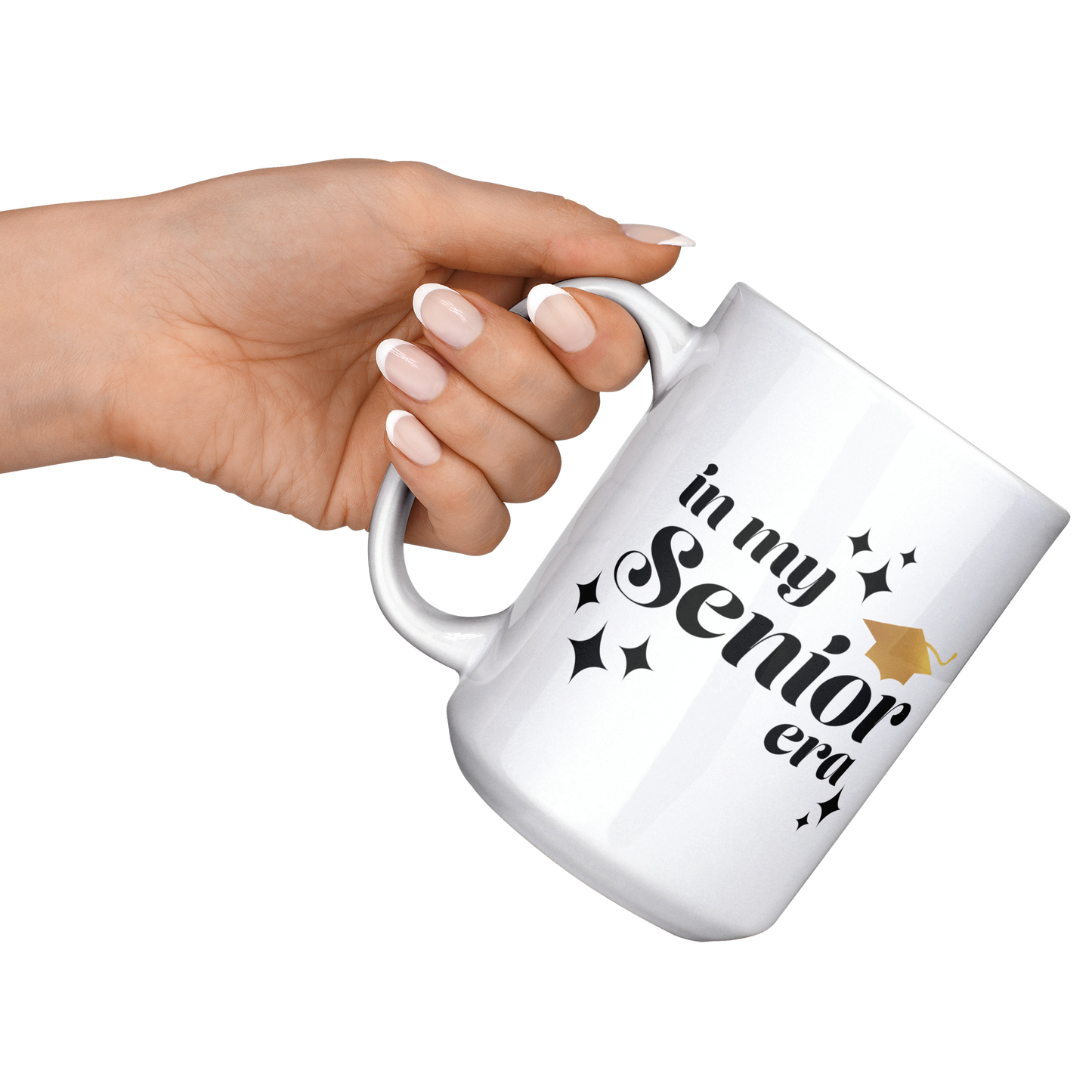 15oz white mug with the text "In My Senior Era" in black and a gold graduation cap being held at an angle by one hand.