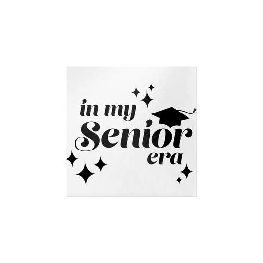 White square sticker with the phrase “In My Senior Era” and a graduation cap in black ink laying flat.