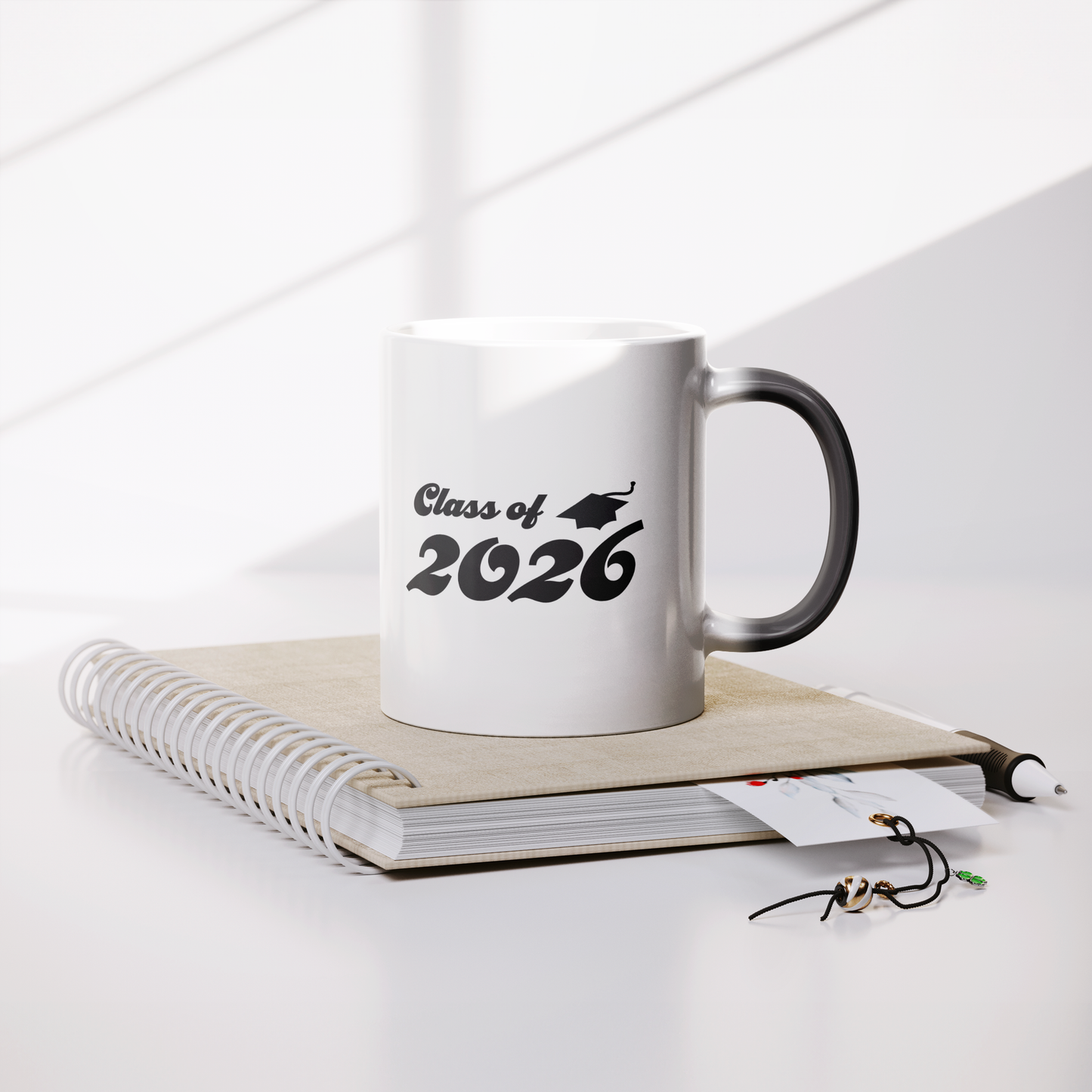 Class_of_2026_11oz_Color_Changing_Mug_Lifestyle_Notebook_Mockup.png