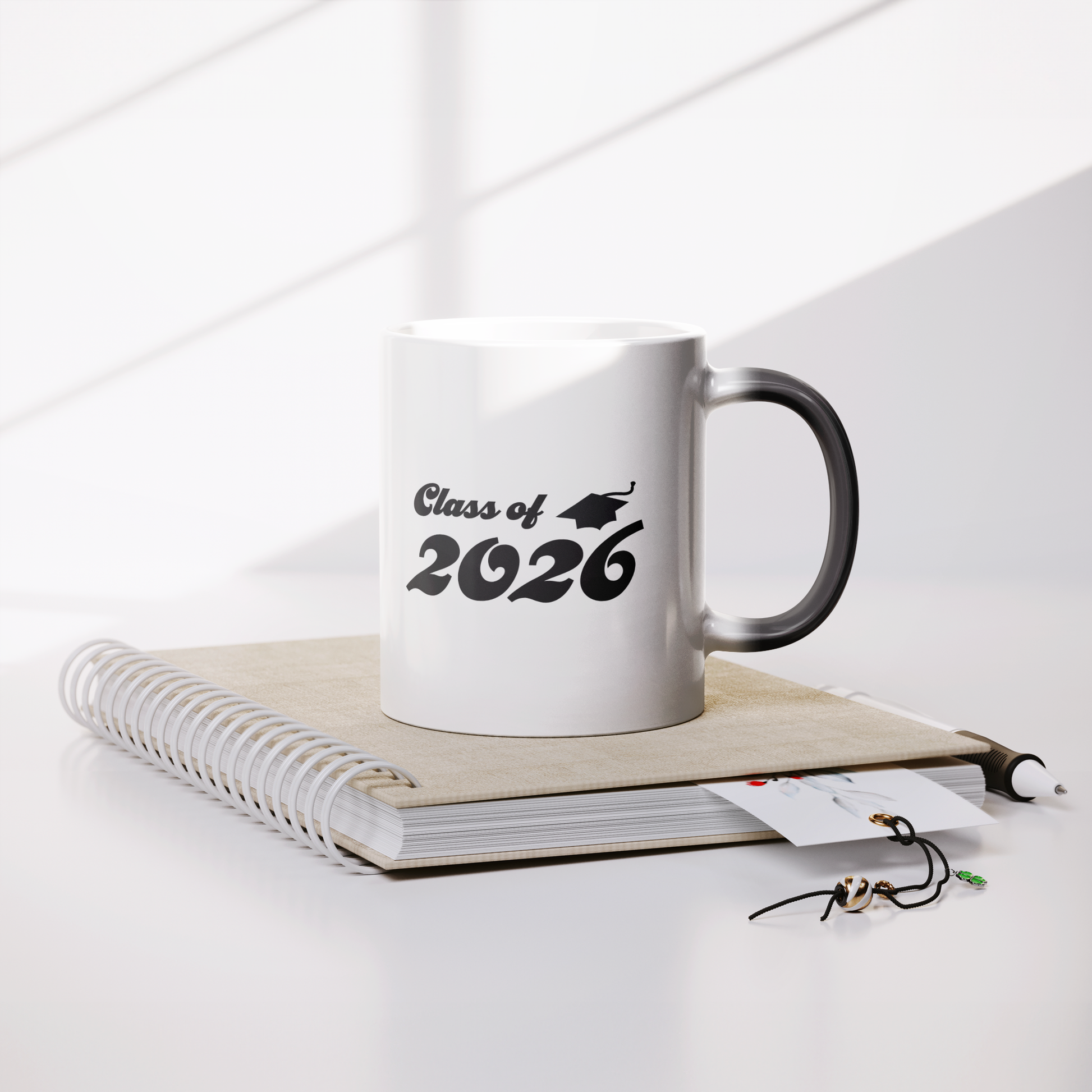 Class_of_2026_11oz_Color_Changing_Mug_Lifestyle_Notebook_Mockup.png