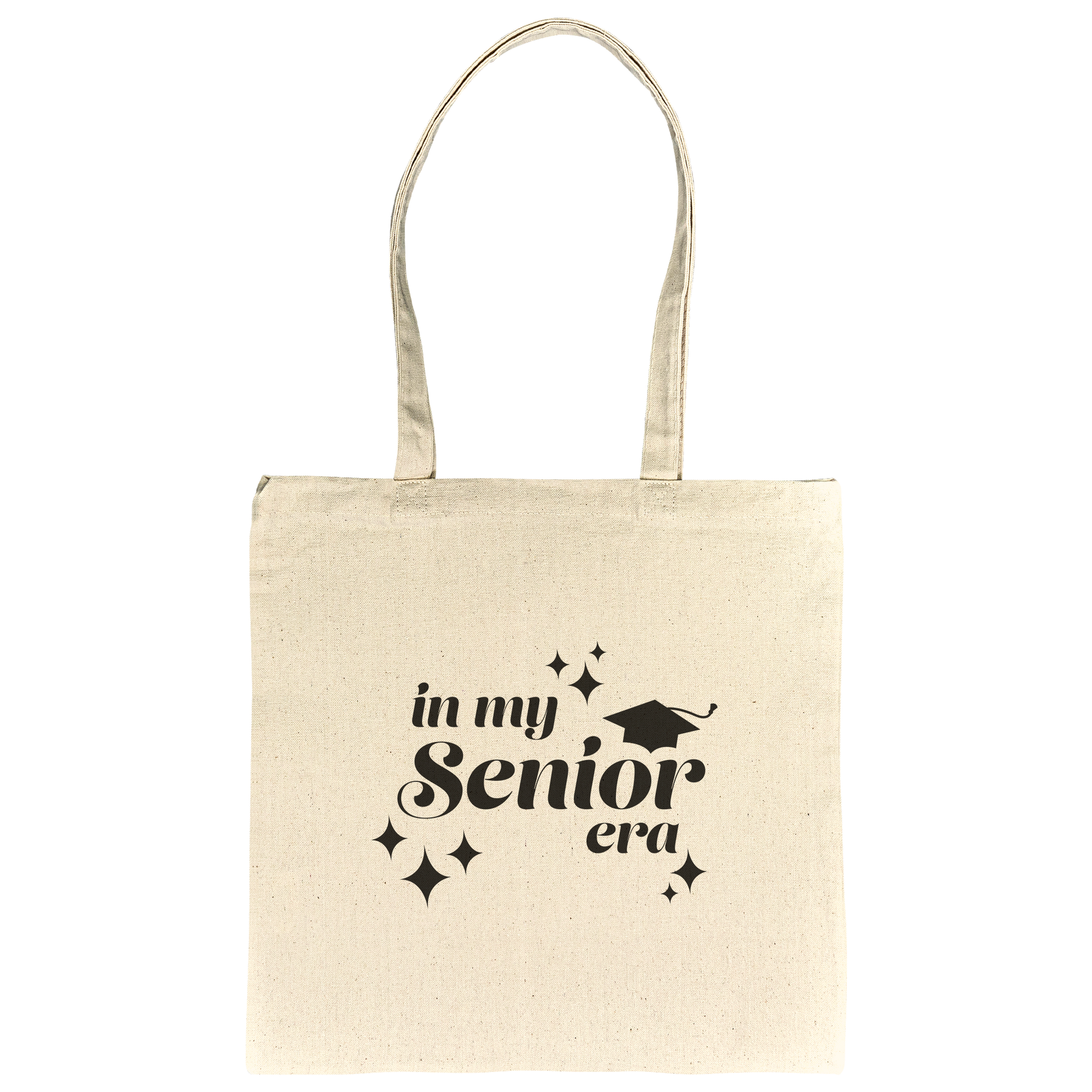 Tan canvas tote bag with the phrase “In My Senior Era” and a graduation cap printed in black ink laying flat