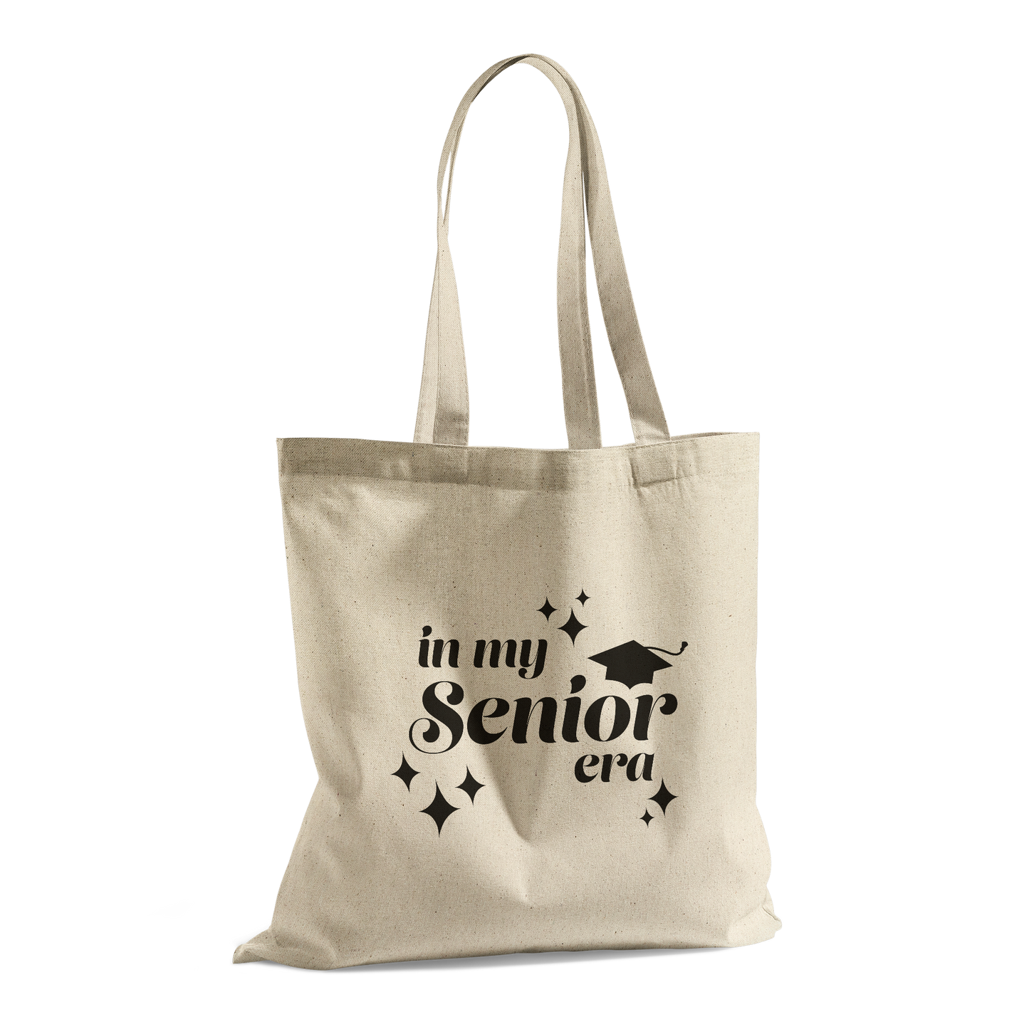 Tan canvas tote bag with the phrase “In My Senior Era” and a graduation cap printed in black ink.