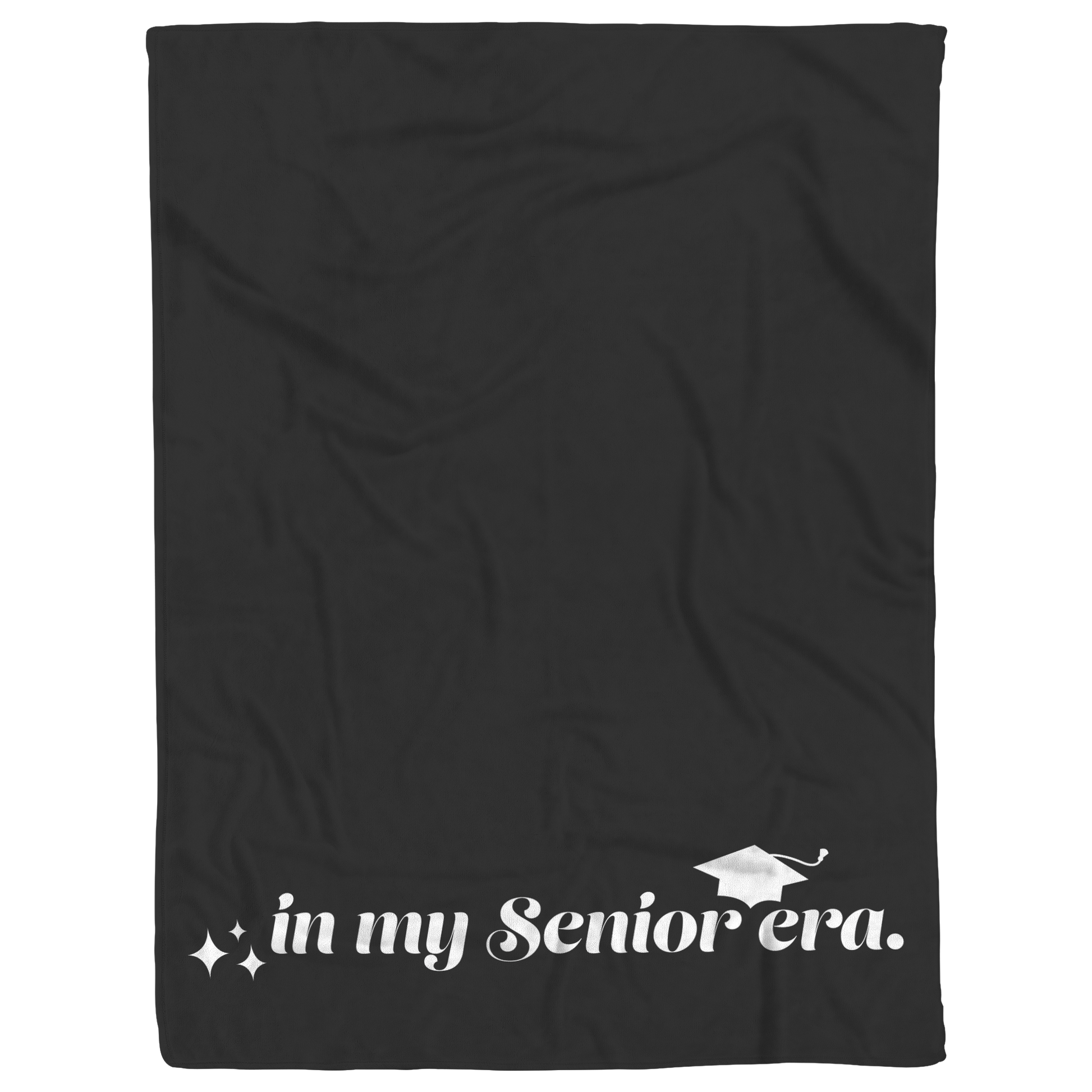 A black fleece blanket with the phrase "In My Senior Era" and a graduation cap in white at the bottom laying flat.