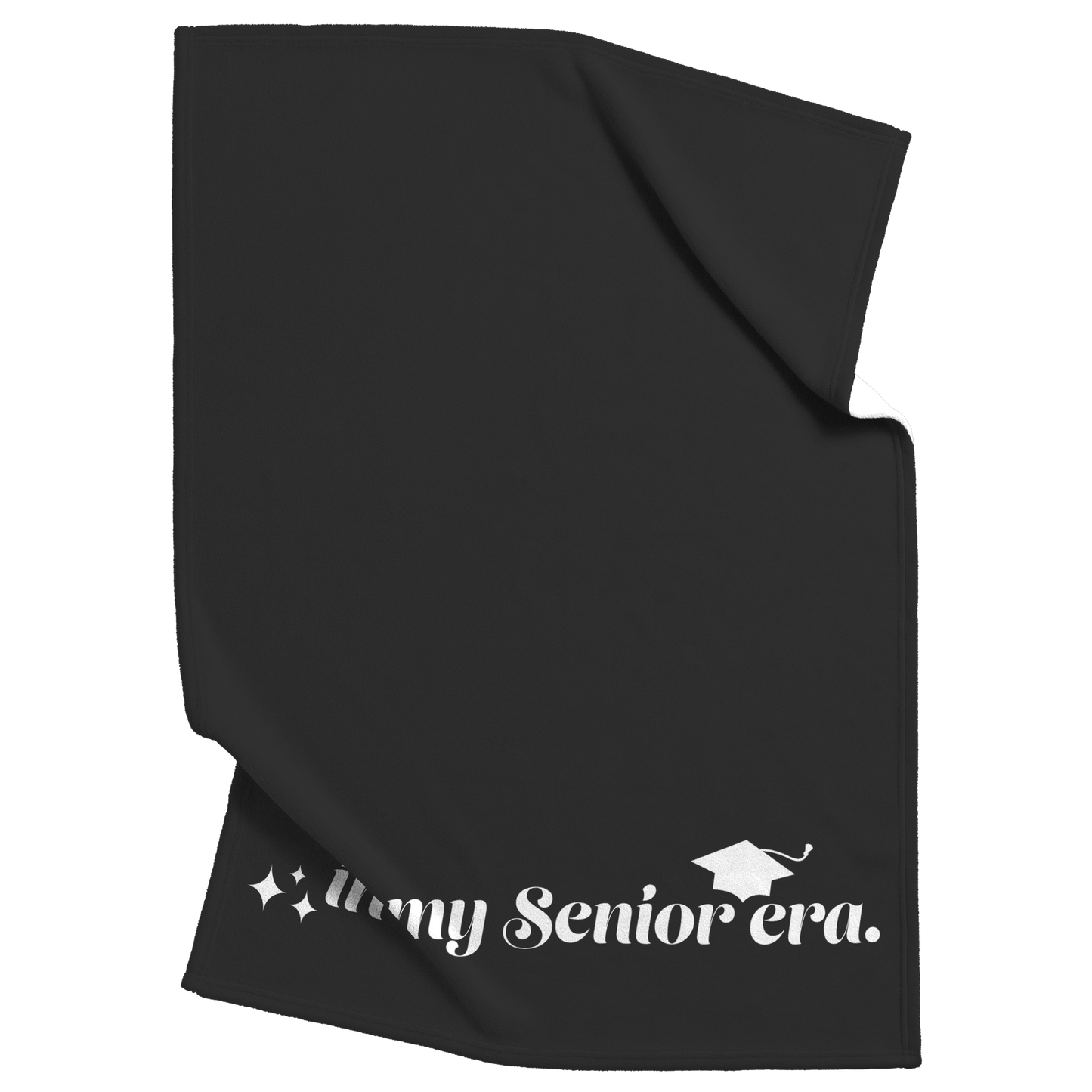 A black fleece blanket with the phrase "In My Senior Era" and a graduation cap in white at the bottom scrunched up in the top right and the bottom left.