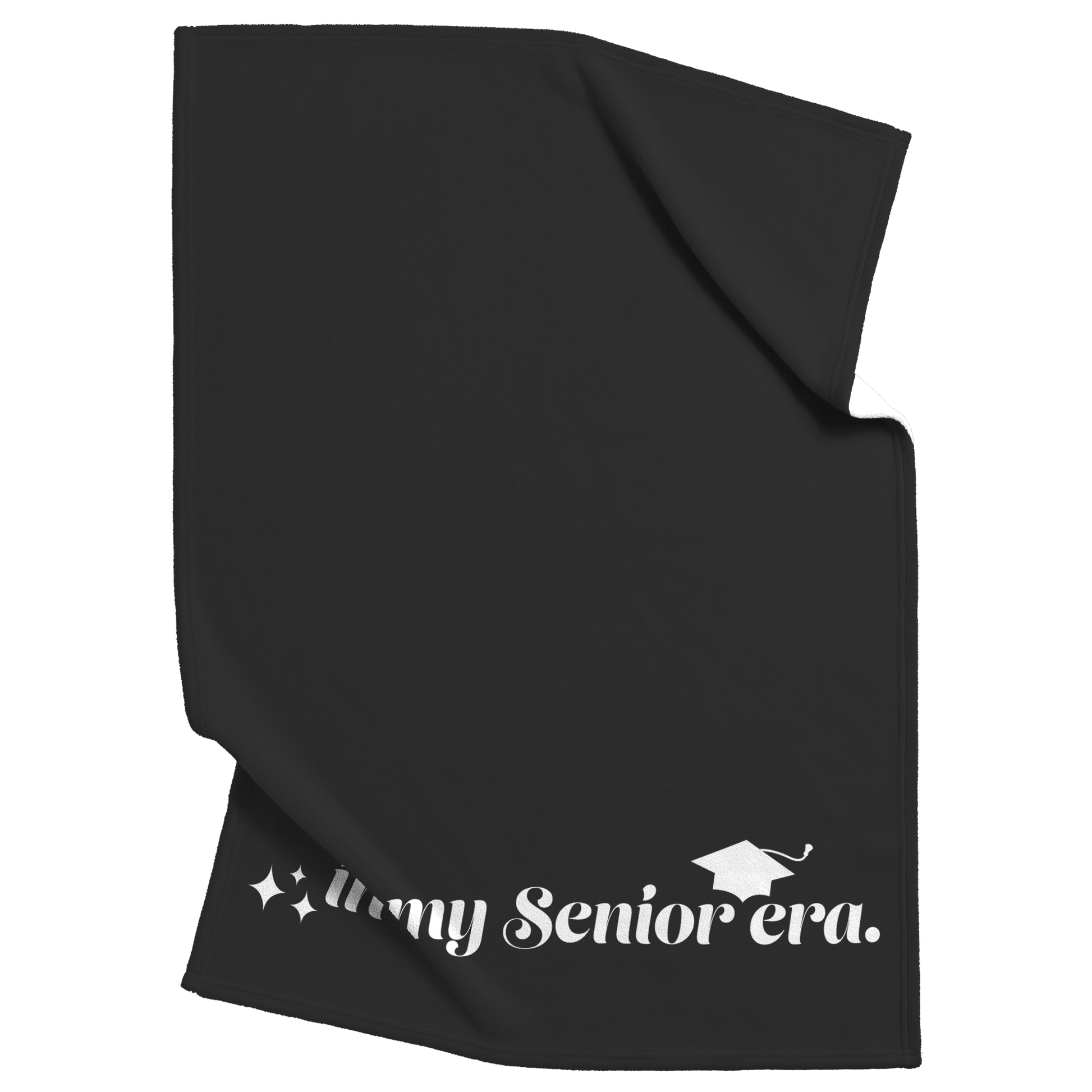 A black fleece blanket with the phrase "In My Senior Era" and a graduation cap in white at the bottom scrunched up in the top right and the bottom left.