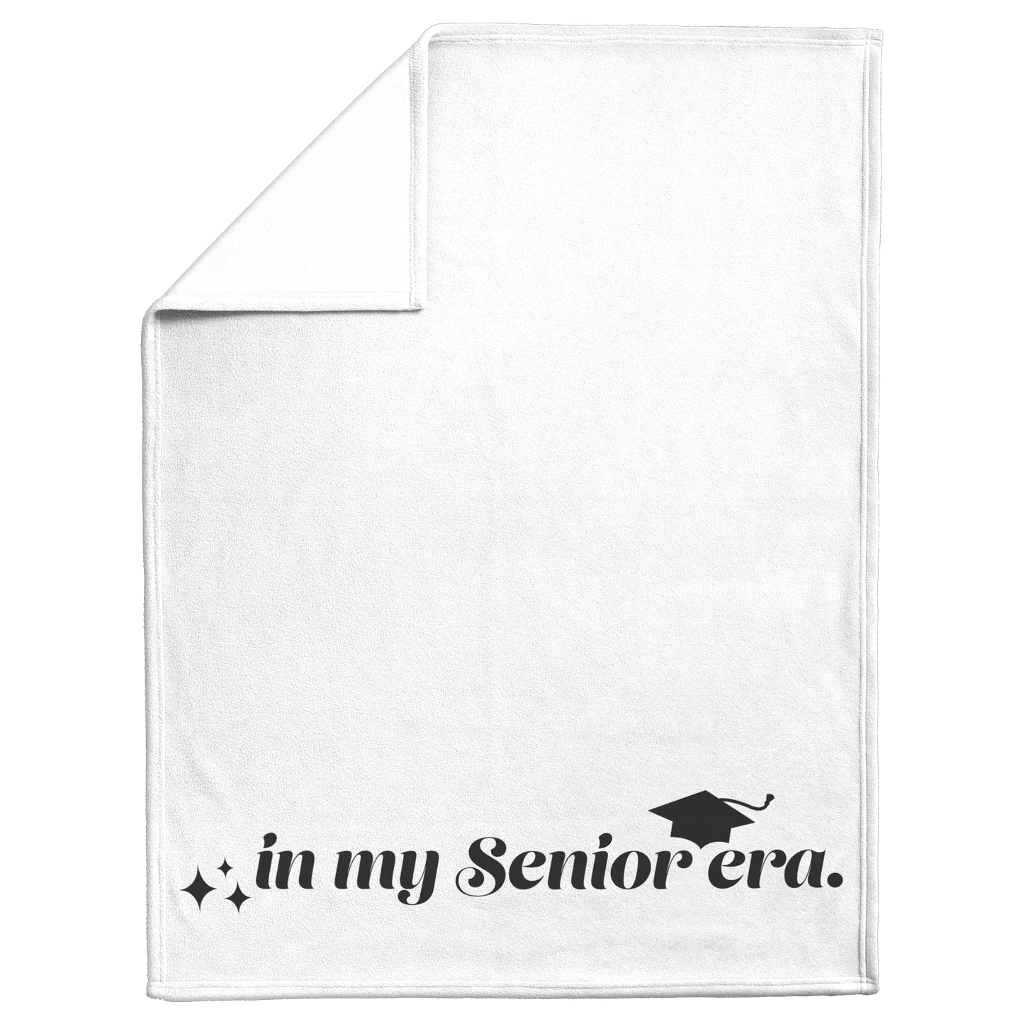 A white fleece blanket with the phrase "In My Senior Era" and a graduation cap in black at the bottom folded down at the top left to show the white back.