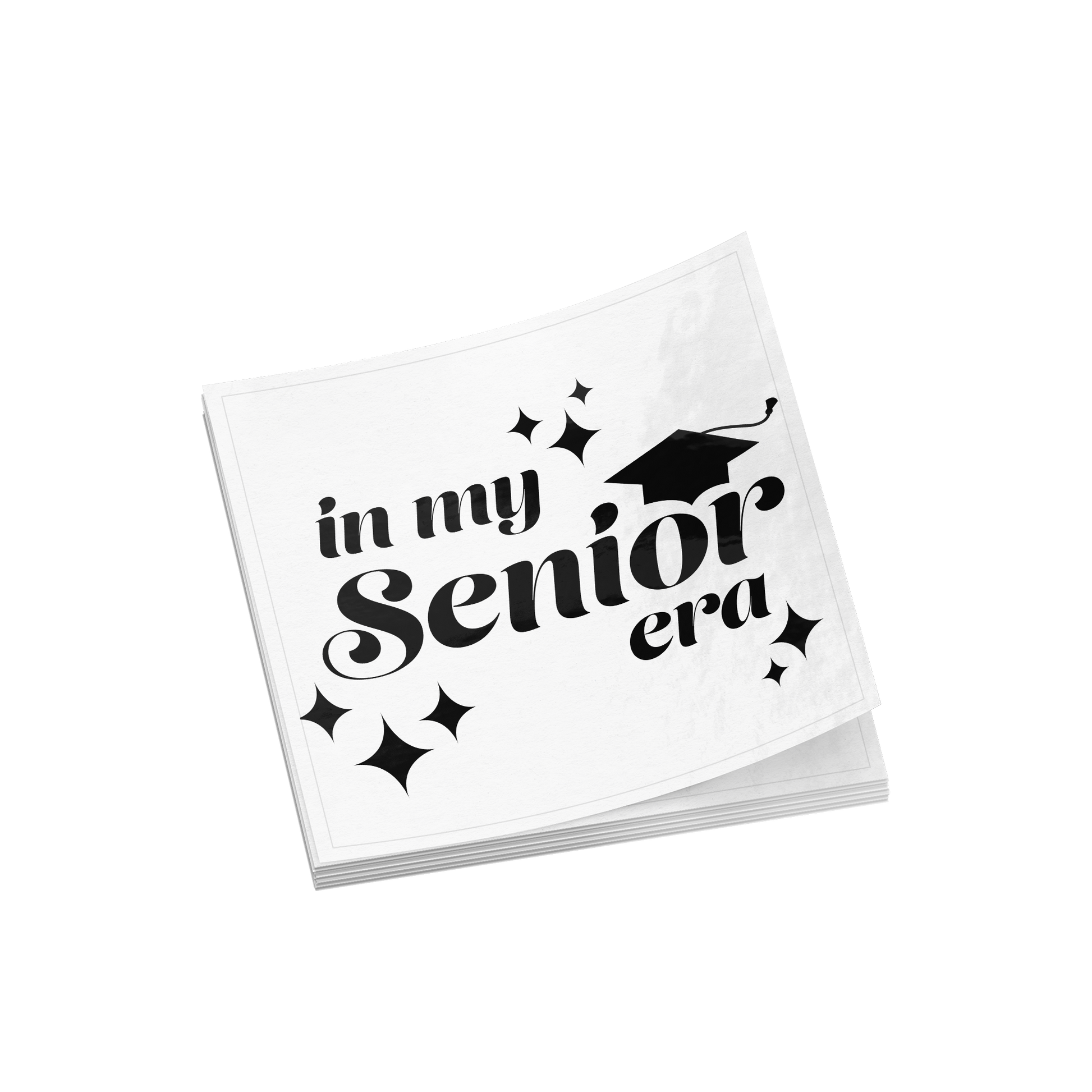 Stack of multiple white square stickers with the phrase “In My Senior Era” and a graduation cap in black ink placed in the middle.