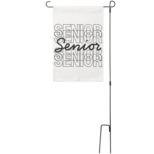 White garden flag with Senior repeated 5 times in black, stacked on top of each other, with the middle one in script text. Sign hung from a wire stand. 