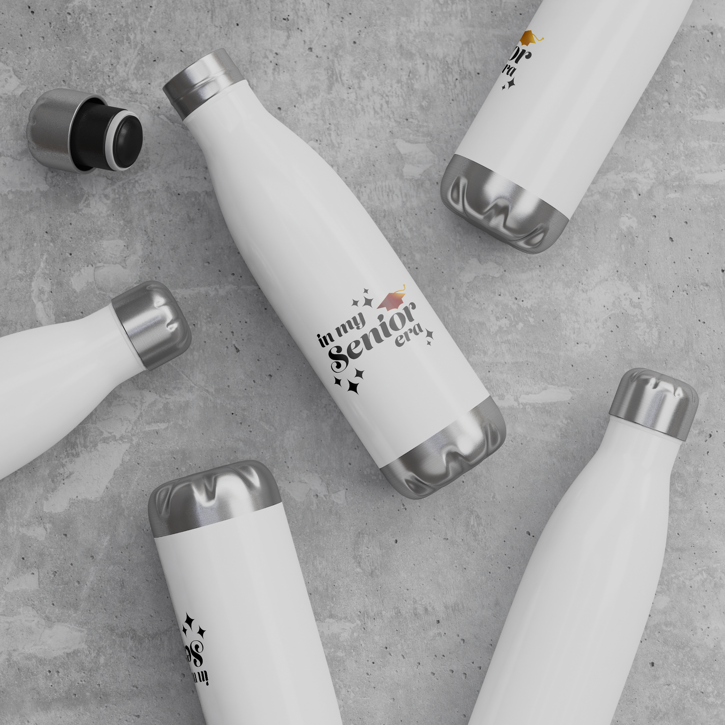 5 white, 20oz water bottles with a silver lid and base laying down scattered on surface. Text in the bottom center of the bottle says "In my Senior Era" in black with a gold graduation cap.